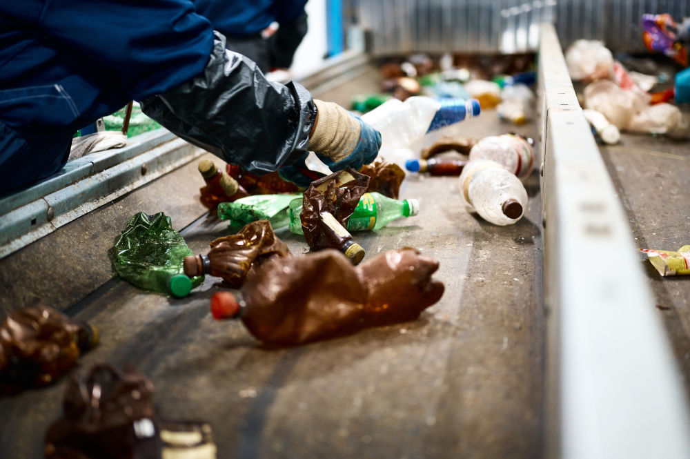 Worker,Sorts,Trash,On,Conveyor,Belt,At,Waste,Recycling,Plant